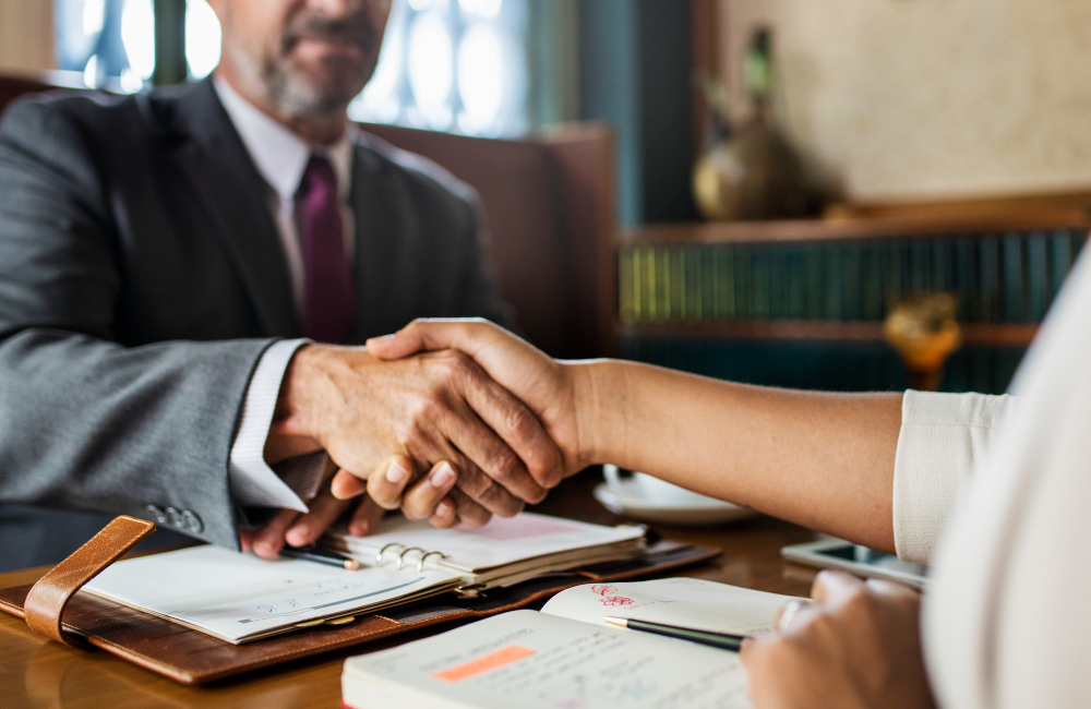 conveyancing lawyer in Glasgow shaking hands with client